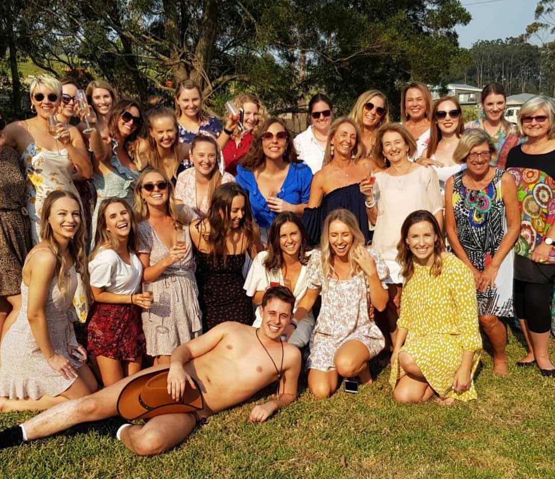 Bride and bridesmaids enjoying life drawing class with male model at Sydney venue
